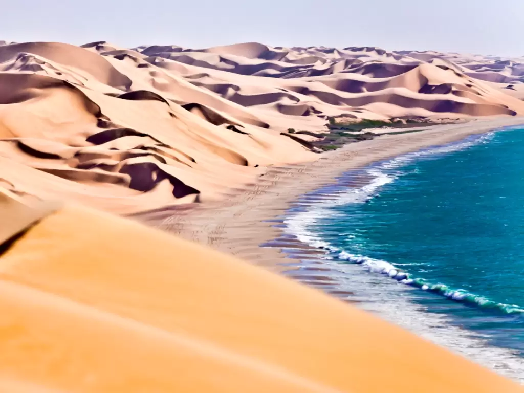 Where desert dunes kiss the Atlantic Ocean—Skeleton Coast, Namibia, offers a surreal and breathtaking union of sand and sea. 