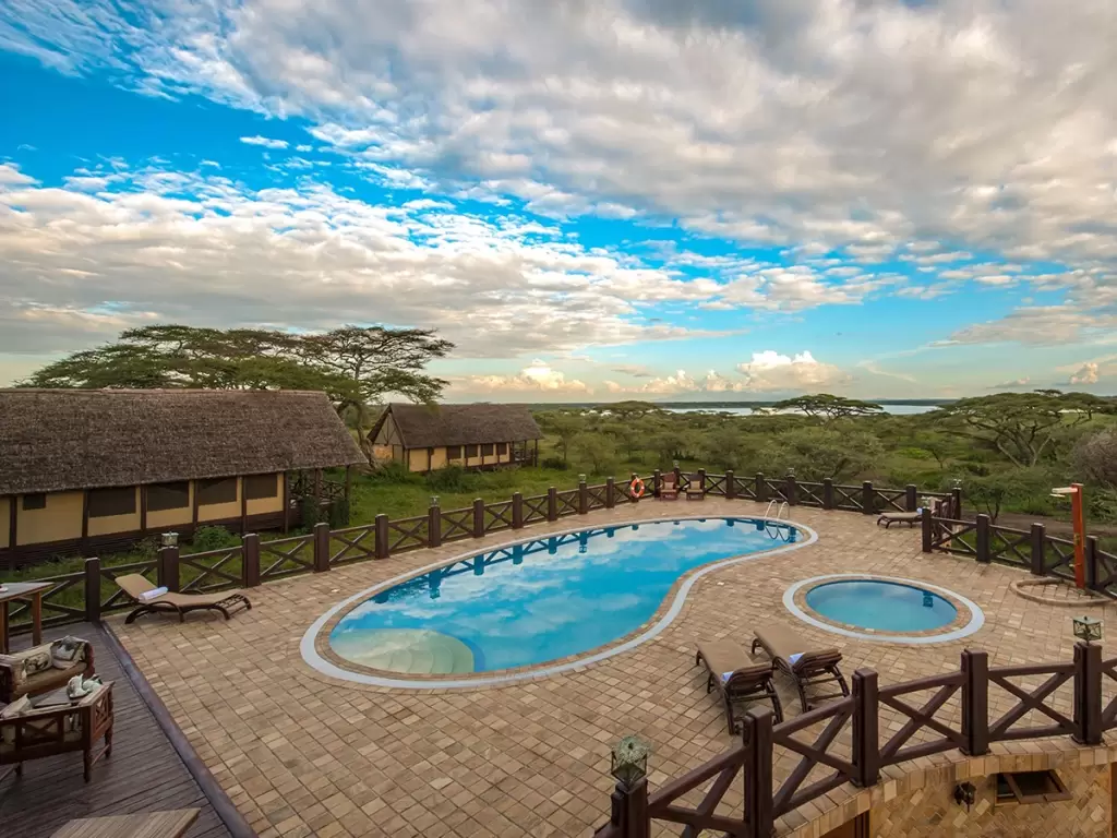 Serene pool area at Lake Ndutu Luxury Lodge offering wilderness views for luxury African safaris.