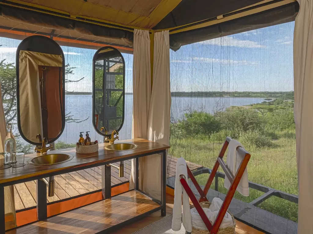 Safari tent interior with lake views, part of Simbavati’s luxury African safari experience.