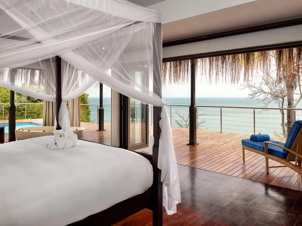Oceanview luxury suite in Mozambique’s Bazaruto Island with canopy bed, private deck, and plunge pool.